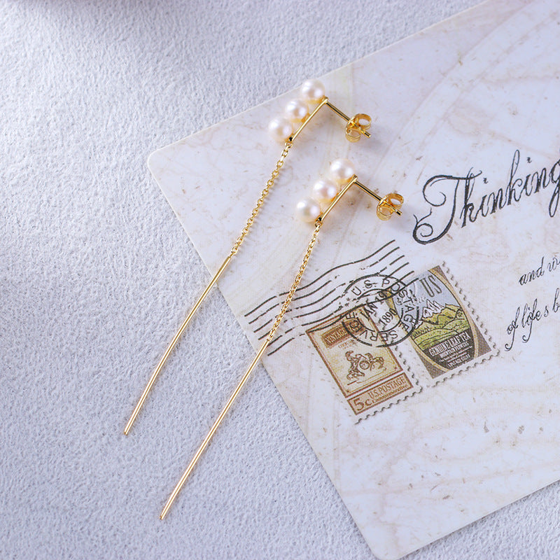 Boucles d'oreilles en perle naturelle sur carte postale