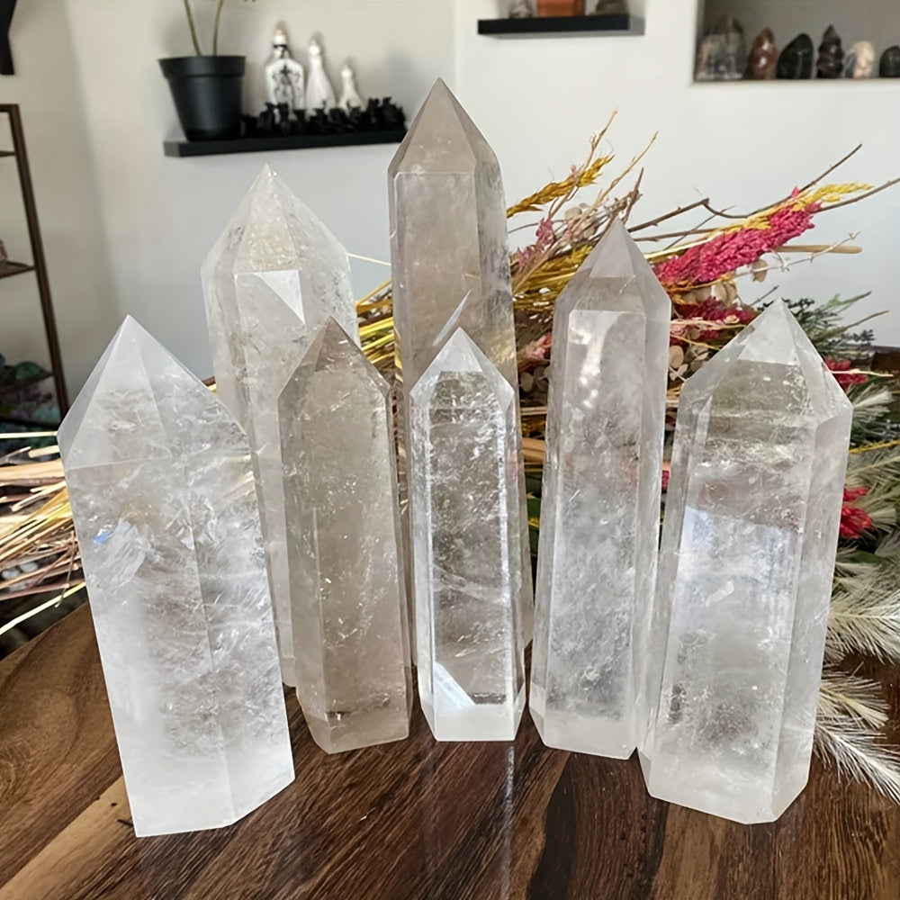 Différentes obélisques en quartz naturel transparent de tailles variées exposées sur une table, parfaites pour Reiki, équilibre énergétique et décoration.