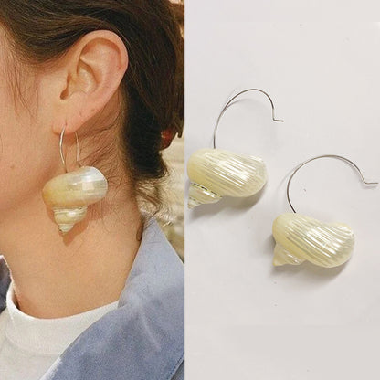 Boucles d'oreilles coquillage sur modèle