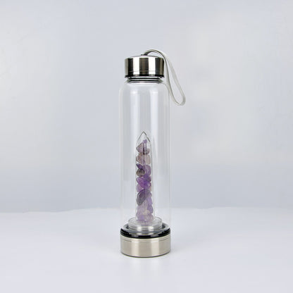 Botella de vidrio de alta calidad con piedras de cristal natural.