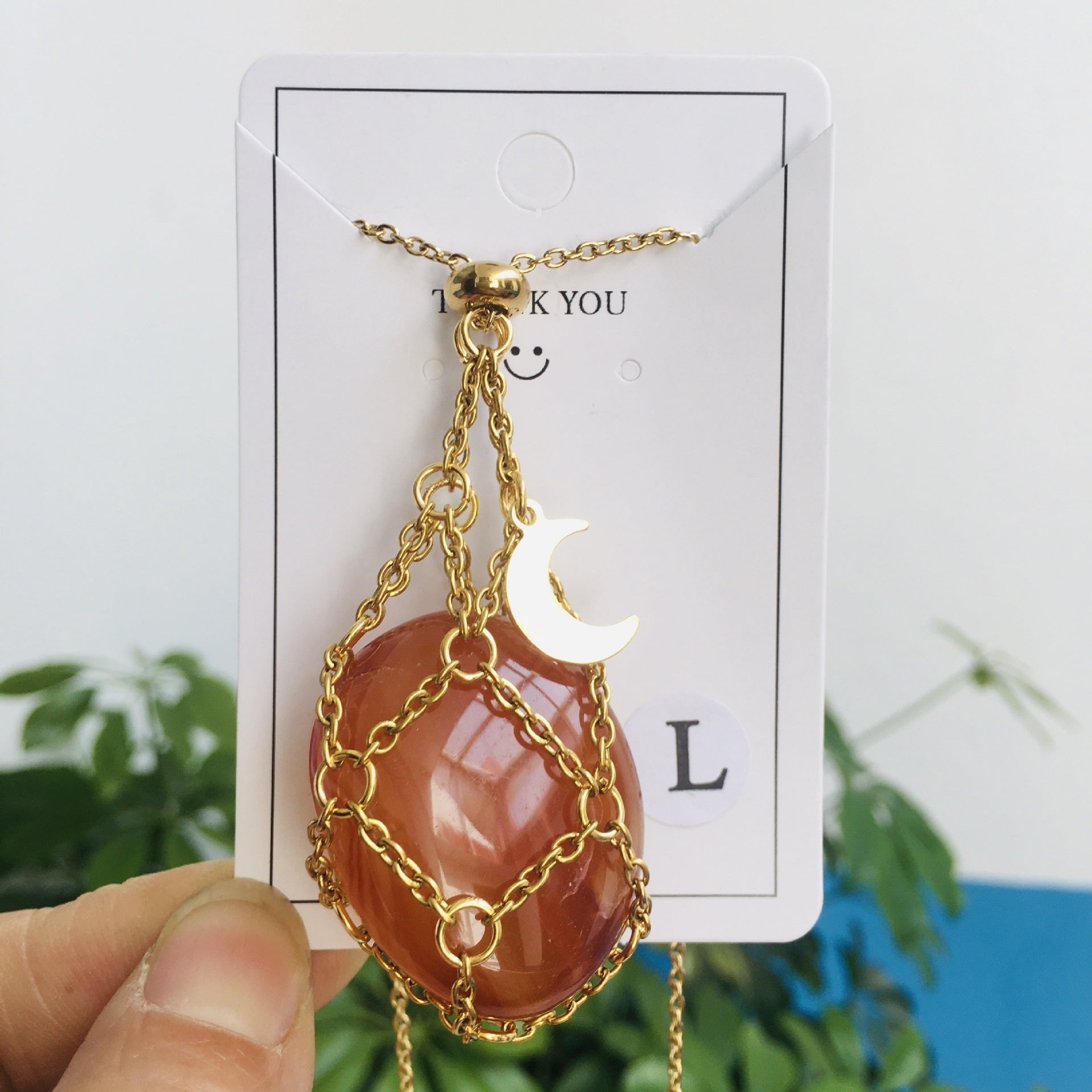 Collier cristal orange avec pendentif lune dorée